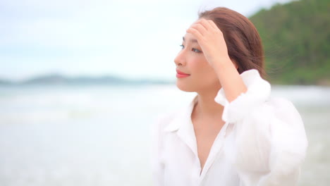 portrait of a happy joyful pretty exotic asian woman with long hair and smile in tropical exterior looking around, full frame slow motion