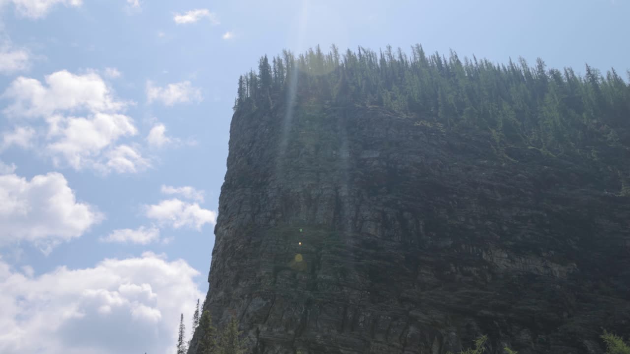 Beautiful view of a rocky mountain top from the hiking trail up to Lake Agnes Tea House on Mount St. Piran and Mount Whyte, within Banff National Park near Lake Louise Alberta.
