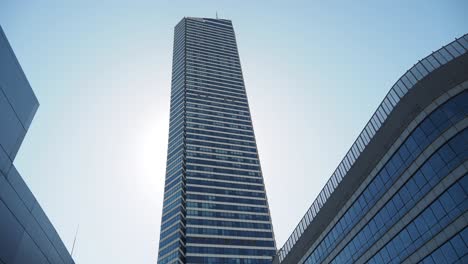 tall skyscraper with glass facade in a sunny day