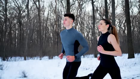 Couple Running in Snowy Forest