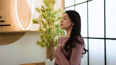 brunette person doing yoga indoors