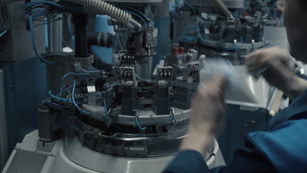 A man prepares a workplace at the garment factory