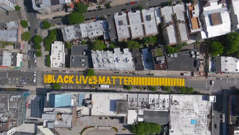 high aerial over the black lives matter blm mural on street top down brooklyn new york