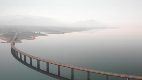 aerial panning shot of long lake bridge with