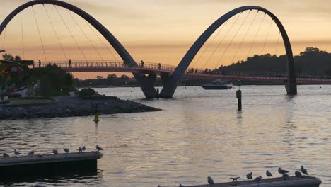 warm sunset over elizabeth quay in perth with silouhettes