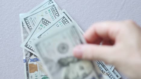american currency hundred dollars bills falling down on grey background