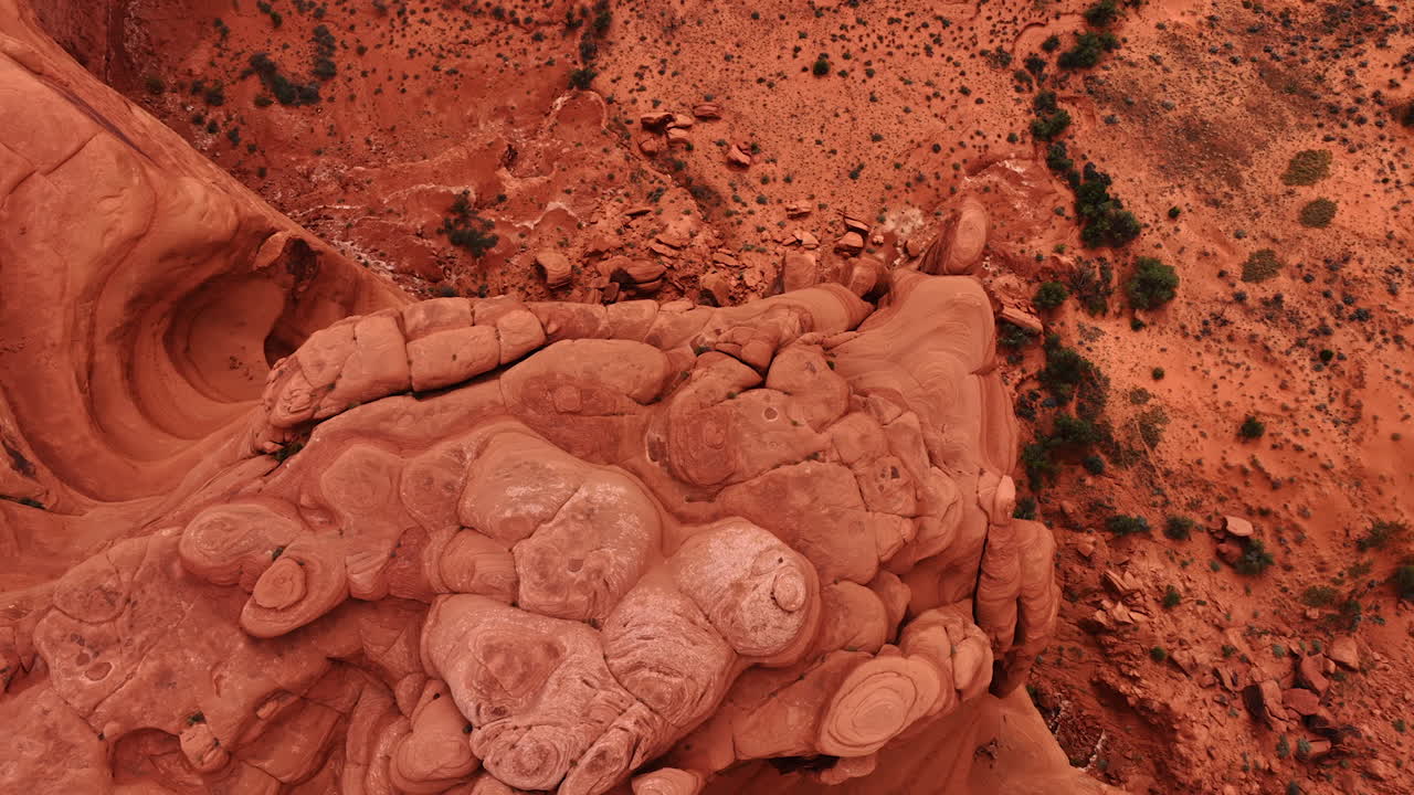 Rising over the rounded tops of the red rocks. Scenery of the Arches National Park, Utah, USA