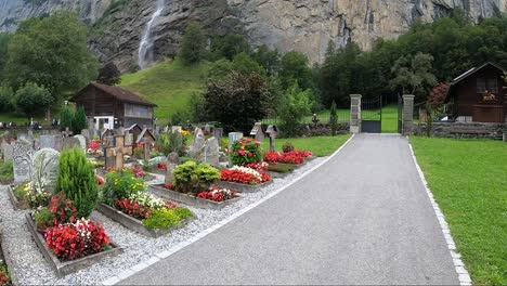 Lauterbrunnen-townscape-and-waterfall-drone-aerial-view-above-swiss-mountains-in-alps