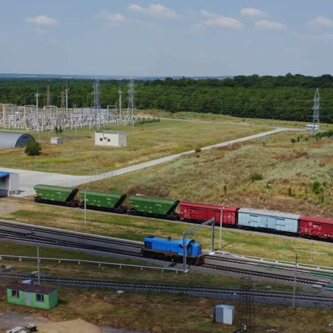 cargo wagon moving alone. freight train traveling to the modern plant for grain storage. railroad with freight carriages on industrial zone background.