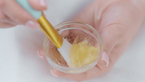 applying a gold-infused face mask