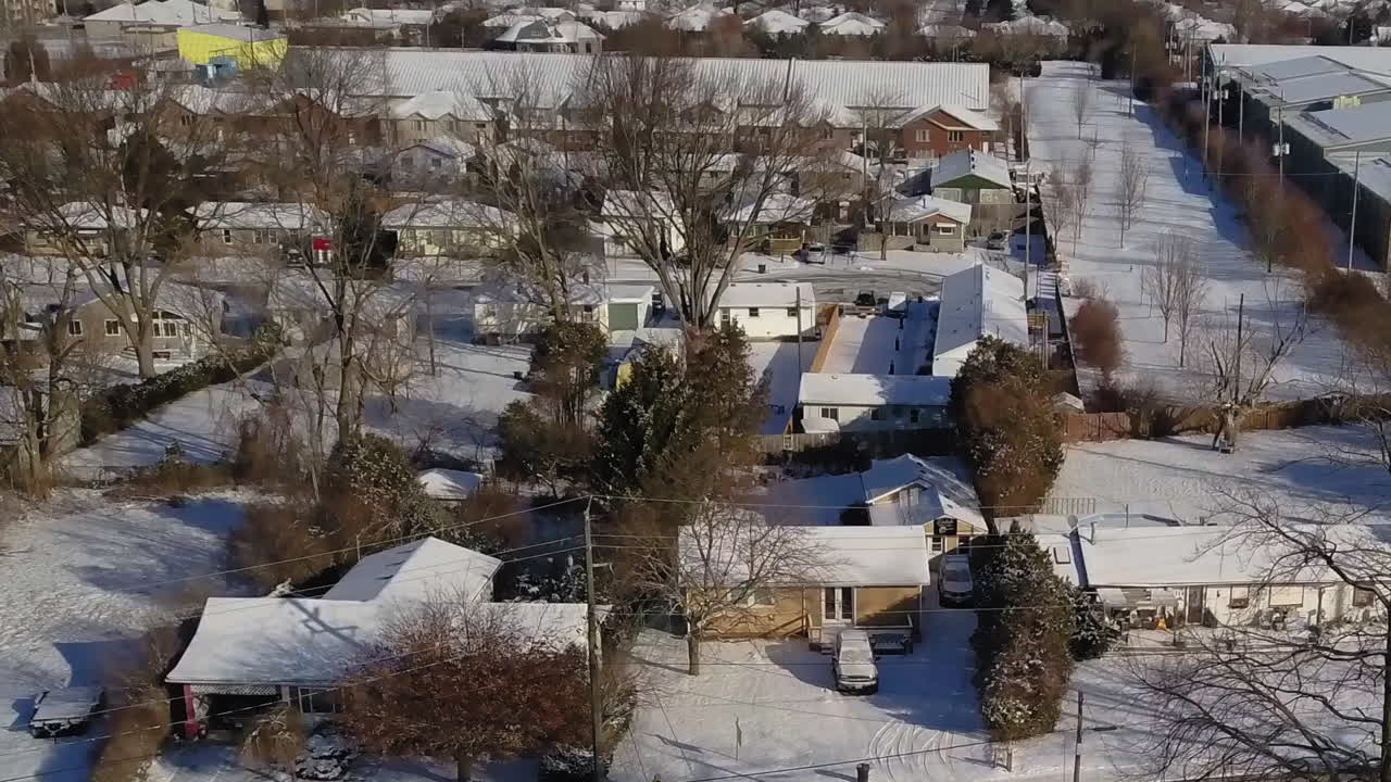 Above view of a small snowy town and busy highway nearby