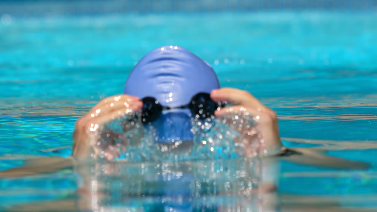 Male swimmer rising up from water 4k