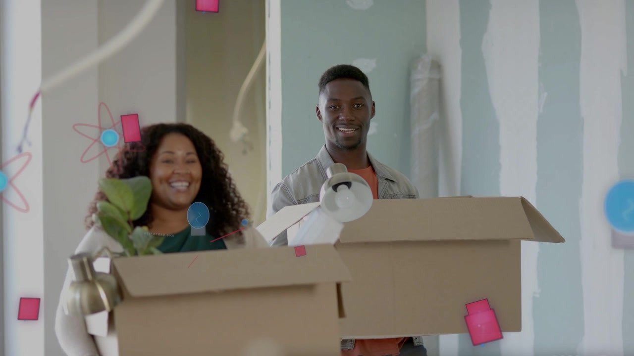 Couple entering renovating home carrying boxes with plant lamp, pink blue shapes over them