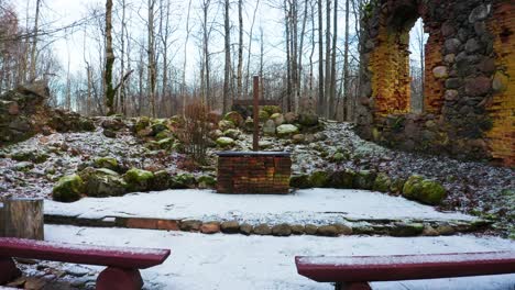 Outdoor-cross-near-abandoned-church-boulder-wall-remains-with-new-red-seats