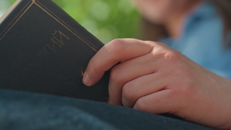 relaxed caucasian woman sitting peacefully with book, serene lady quietly resting while holding closed book in her lap, tranquil woman with light skin gently reads book while seated calmly