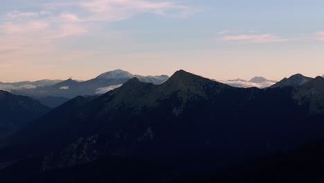 Exposed-ridgeline-and-peaks-in-mountains-of-Agrafa-with-gentle-soft-clouds-gathered-below-rocks