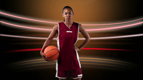 female basketball player against light trails on black background