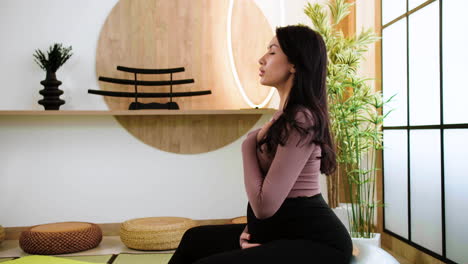 side view of person doing yoga indoors