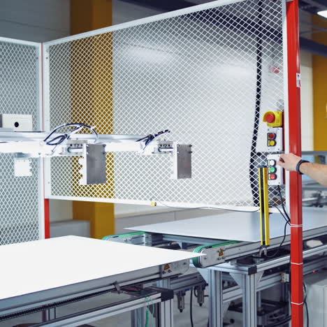 modern factory background. worker controls the work on a conveyor during making new details. industrial interior.