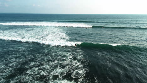 Popular-destination-Batu-Bolong-beach-crowded-with-surfers,-Bali,-Indonesia,-aerial-view