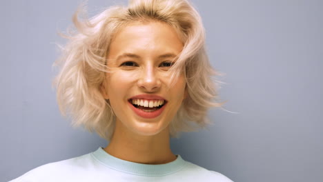 woman with short blonde hair smiling