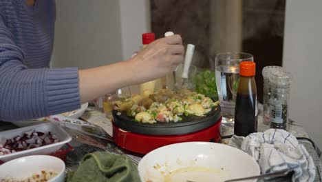 takoyaki being prepared by japanese woman at home