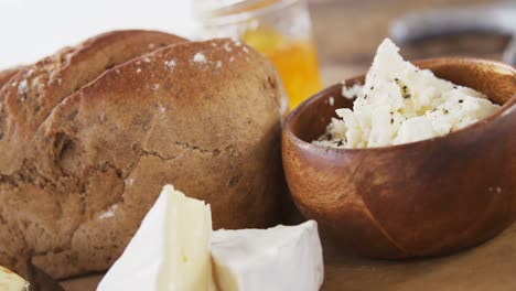 Loaf-of-bread-with-cheese,-knife-and-jam