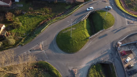 aerial view of cars circling around the double roundabout with water canal in the middle