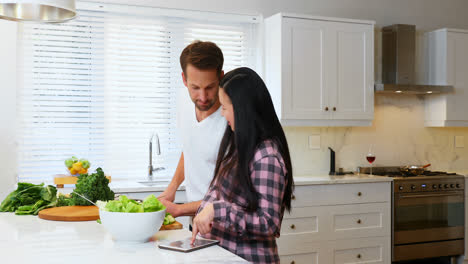 pregnant woman talking to man while cutting vegetable 4k