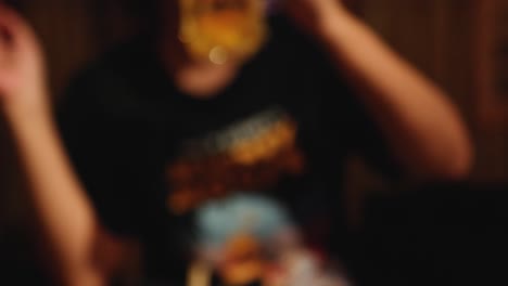 person drinking beer in a casual setting