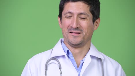 close up of hispanic man doctor smiling while thinking