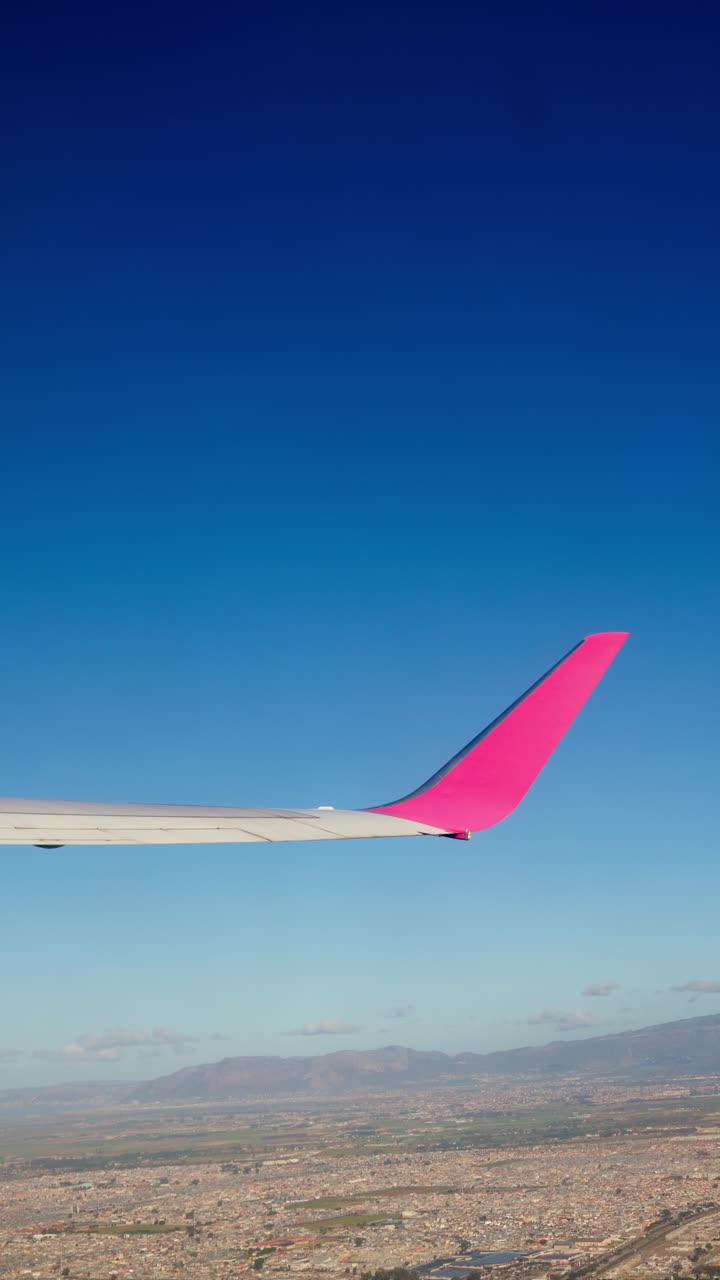 Airplane view of cityscape under blue sky
