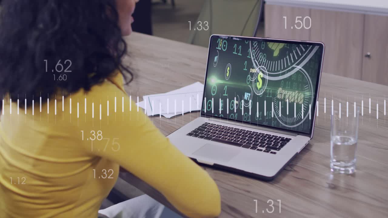 Woman in yellow leaning at table, noticing laptop crypto coin visuals and tracking orange graph