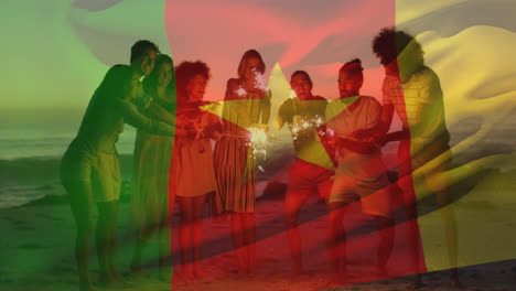 animation der kamerun-flagge über verschiedenen freunden mit funkeln, die sich am strand erfreuen