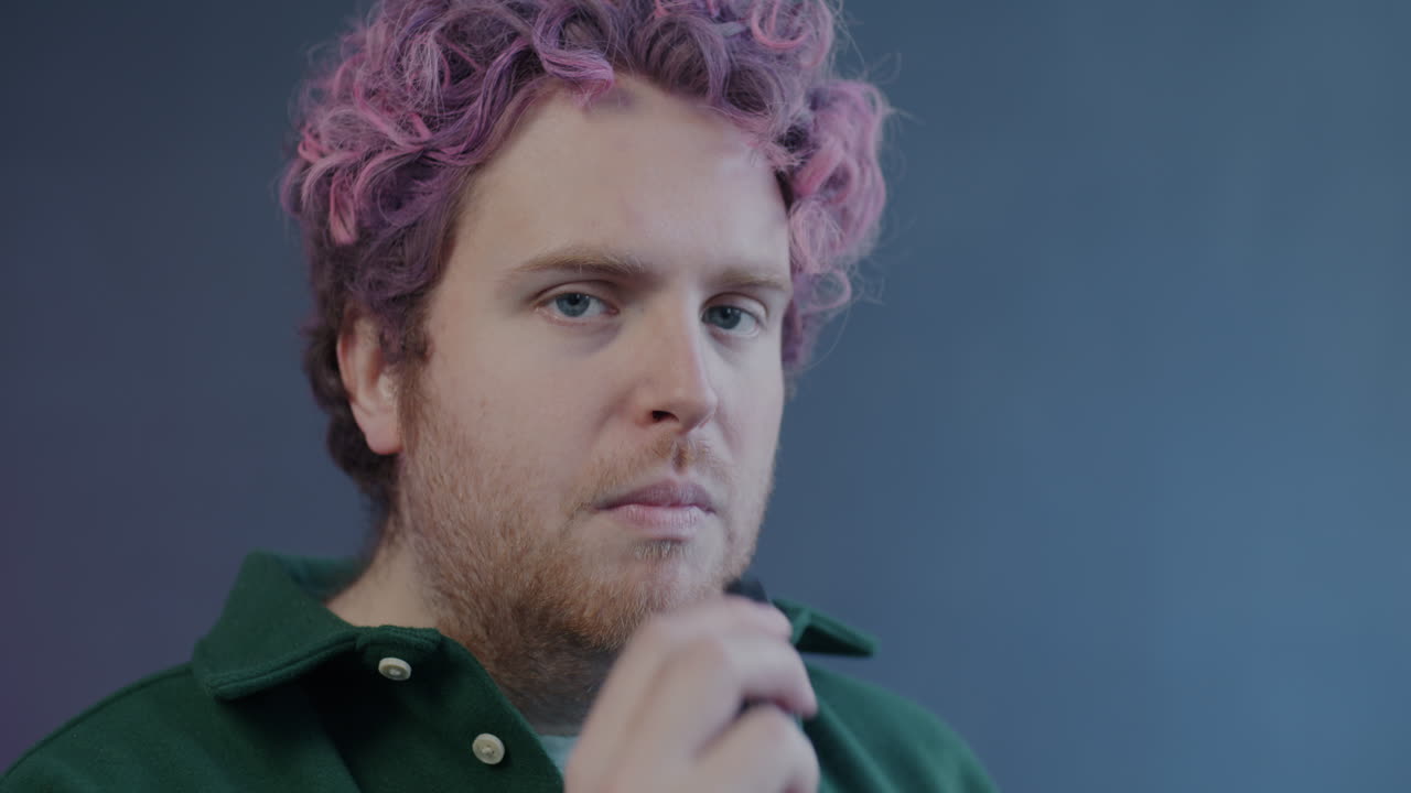 Man with pink hair smoking