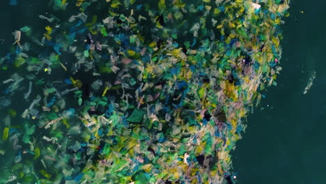 vertical shot of tons of plastic garbage floating in the sea