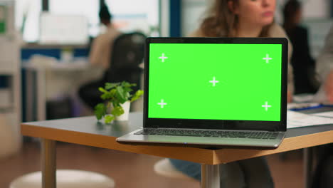 Businesspeople-analysing-financial-reports-sitting-in-back-of-laptop-with-green-screen