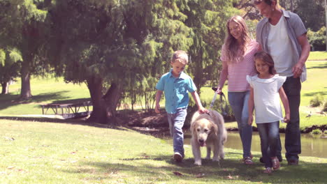 family with dog in the park