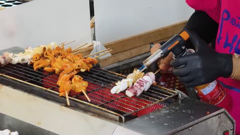 grilled squid skewers being prepared