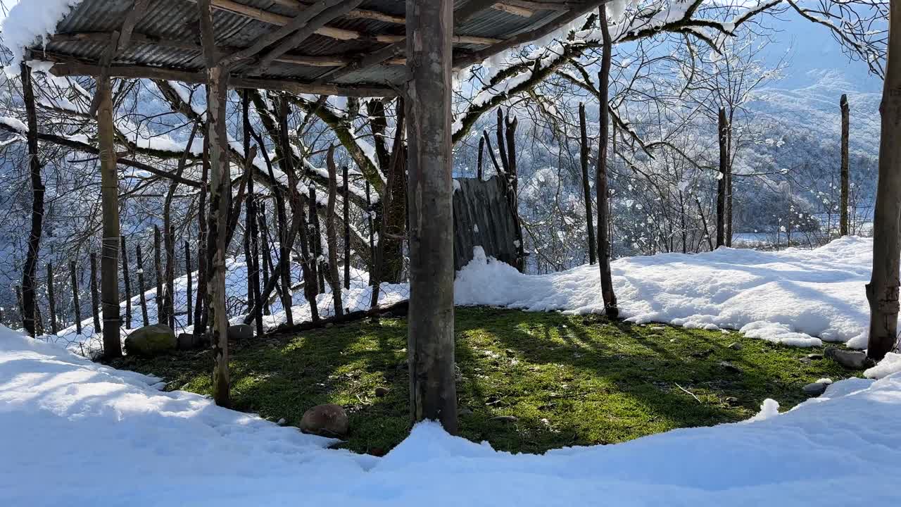 sun shade and shelter in snow wooden hut in rural village iran nature landscape of mountain countryside forest agriculture road handmade traditional local people trees branches outdoors winter season
