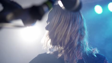 Closeup-cheerful-girl-singer-dancing-on-music-beats-or-rhythm-at-nightclub