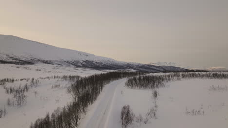 aerial cinematic shot of cold white landscape