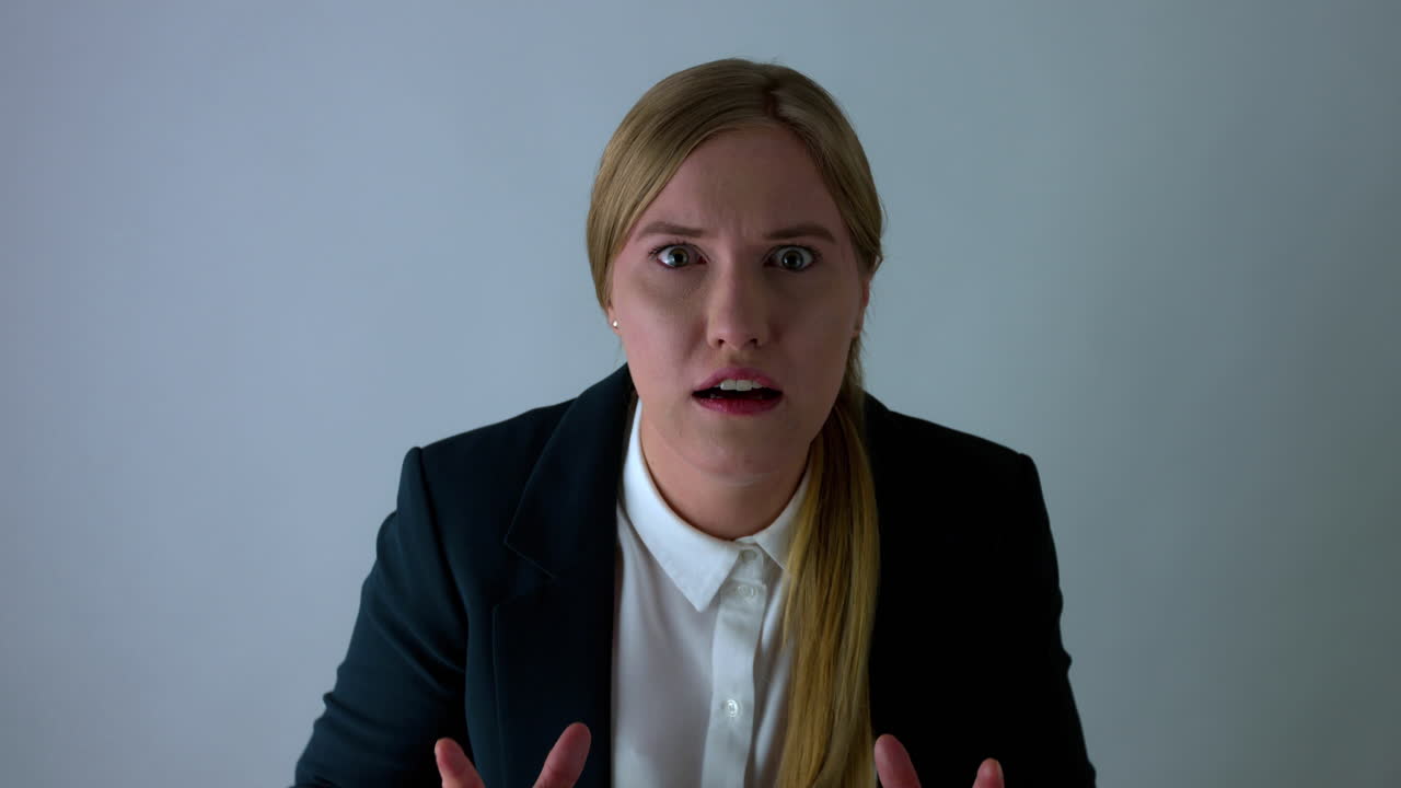 Potrait slow motion shot of shocked woman in business outfit,white background