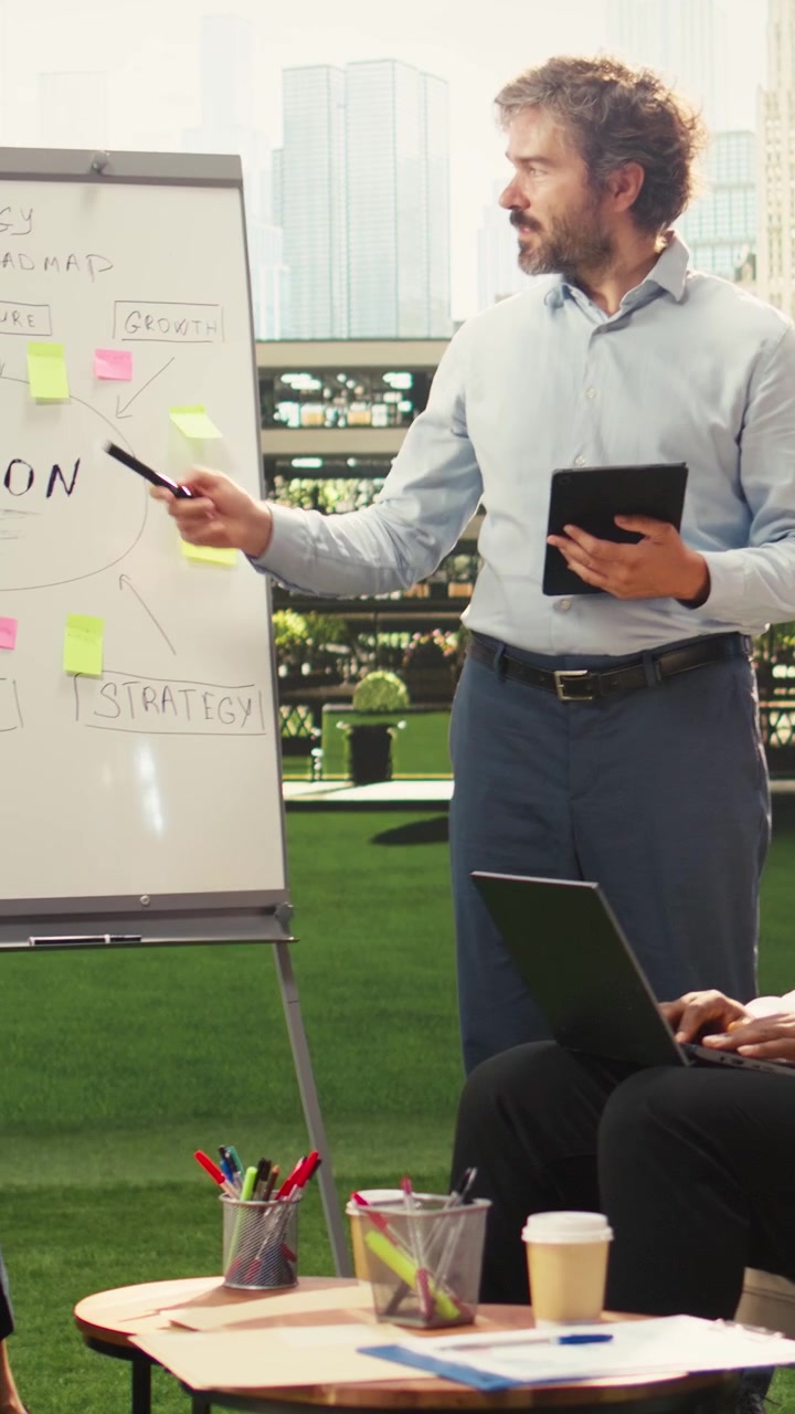 Vertical Video Diverse business people pointing to project timeline to build strategy