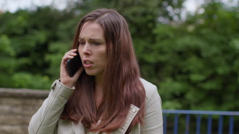 Stressed-Or-Angry-Woman-Outdoors-With-Financial-Worries-About-Cost-Of-Living-Crisis-Debt-And-Paying-Bills-Talking-On-Mobile-Phone-7