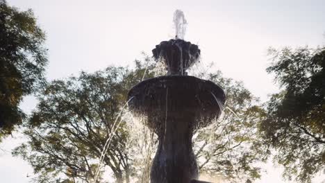 slow motion close up of mermaid fountain in the park of antigua guatemala at sunset