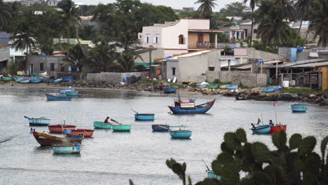 small fishing boats floating on harbor of rural vietnamese beach village