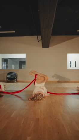 contemporary dance performance with red ribbons