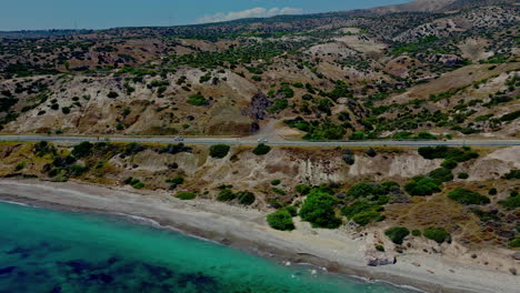 Cars-travelling-through-dry-countryside-along-the-coast-of-the-Mediterranean-sea