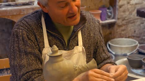 potter working on clay sculpture